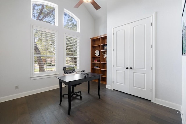 office space with baseboards, dark wood-style floors, high vaulted ceiling, and ceiling fan