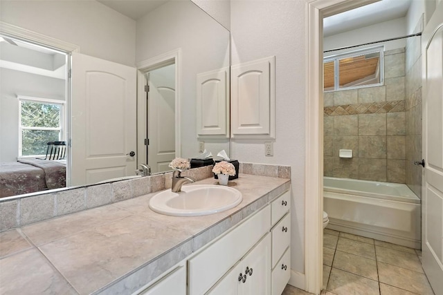 bathroom featuring tile patterned floors, toilet, vanity, and shower / bath combination