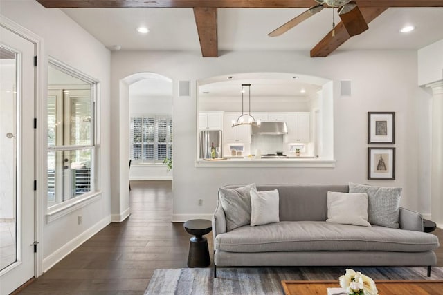 living room featuring baseboards, visible vents, dark wood finished floors, beam ceiling, and recessed lighting