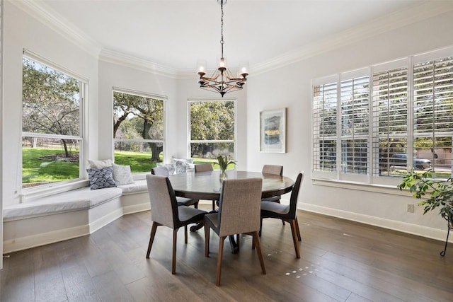 dining space featuring dark wood finished floors, a chandelier, baseboards, and ornamental molding