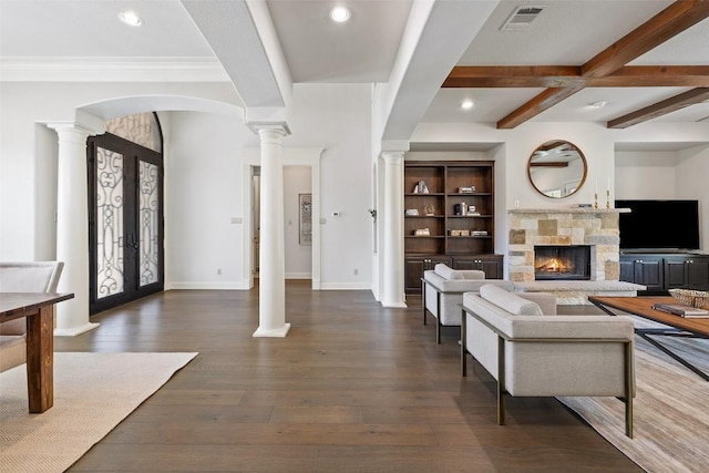 foyer entrance with decorative columns, beamed ceiling, hardwood / wood-style floors, and french doors