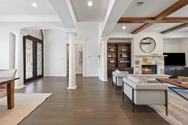 living area with visible vents, french doors, beamed ceiling, wood-type flooring, and decorative columns