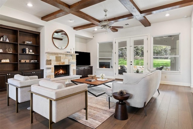 living area with baseboards, coffered ceiling, beam ceiling, a fireplace, and hardwood / wood-style flooring