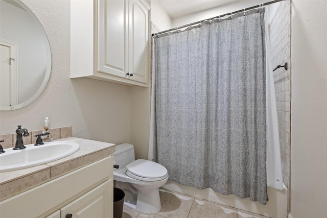 bathroom featuring toilet, vanity, and tile patterned flooring