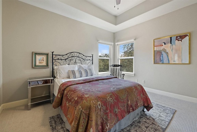 carpeted bedroom featuring a ceiling fan and baseboards