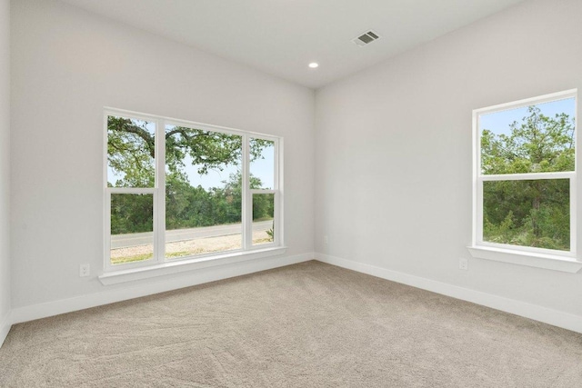 carpeted empty room with visible vents, recessed lighting, and baseboards