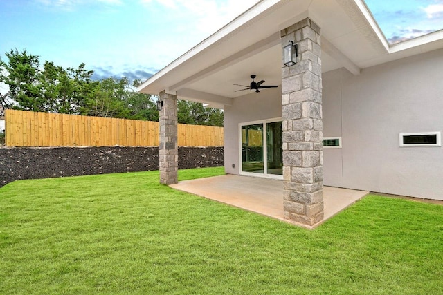 view of yard featuring a patio area, ceiling fan, and fence