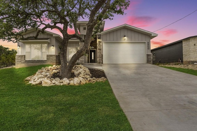 view of front of house featuring stone siding, board and batten siding, concrete driveway, and a garage