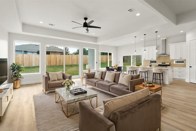 living room with recessed lighting, visible vents, and light wood-style floors