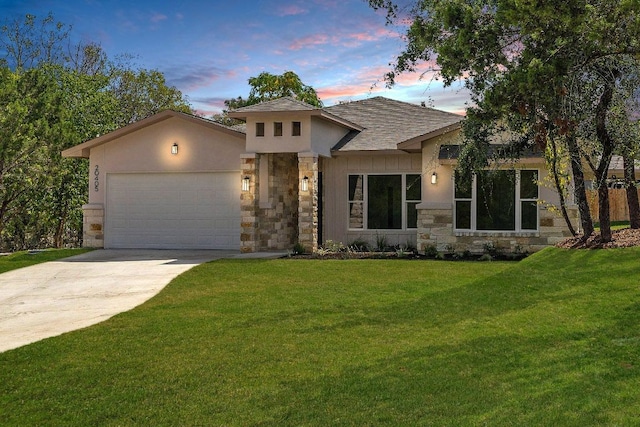 view of front of property with a garage, stone siding, a yard, and driveway