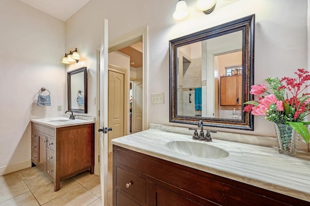 bathroom featuring tile patterned floors, two vanities, and a sink