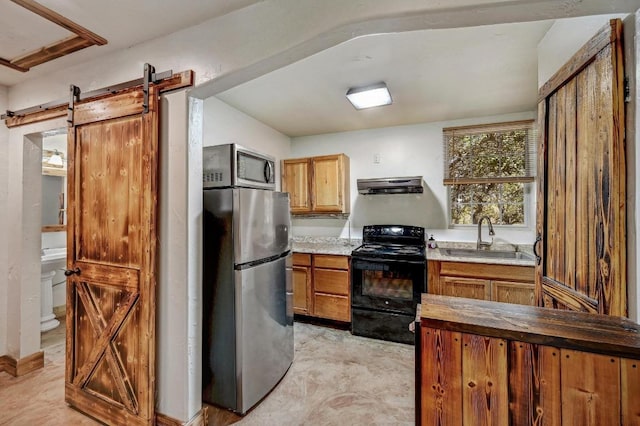 1401 Thurman Rd, San Marcos, TX 78666 - kitchen with stainless steel appliances, a sink, extractor fan, a barn door, and brown cabinetry