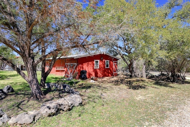 1401 Thurman Rd, San Marcos, TX 78666 - view of property exterior with an outbuilding, a lawn, and a barn
