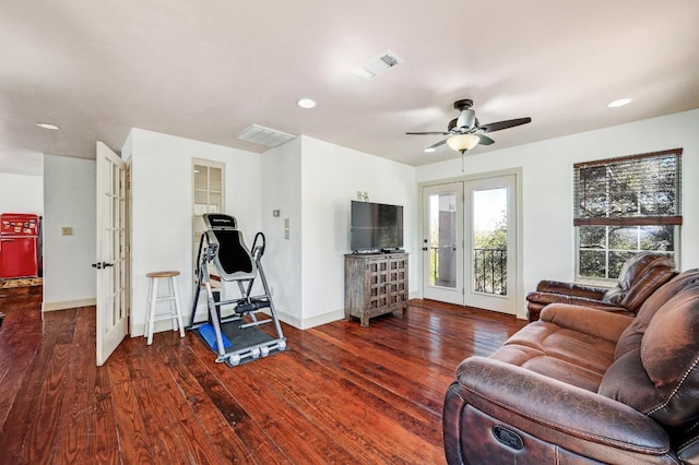 living area with visible vents, french doors, baseboards, and wood finished floors