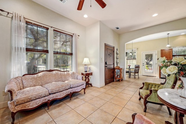 1401 Thurman Rd, San Marcos, TX 78666 - living area featuring light tile patterned flooring, a ceiling fan, baseboards, recessed lighting, and arched walkways