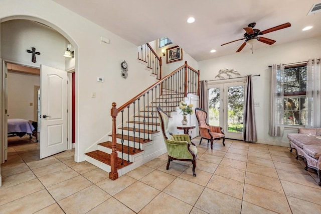 foyer entrance featuring visible vents, light tile patterned flooring, recessed lighting, and arched walkways