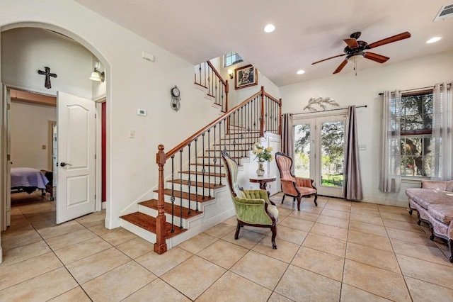 1401 Thurman Rd, San Marcos, TX 78666 - entrance foyer featuring light tile patterned flooring, a ceiling fan, stairs, arched walkways, and recessed lighting