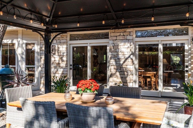 view of patio featuring outdoor dining space and a gazebo