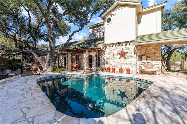 pool featuring a gazebo and a patio