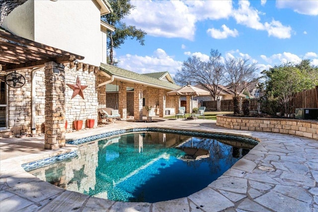 view of swimming pool featuring a patio, fence, and a fenced in pool