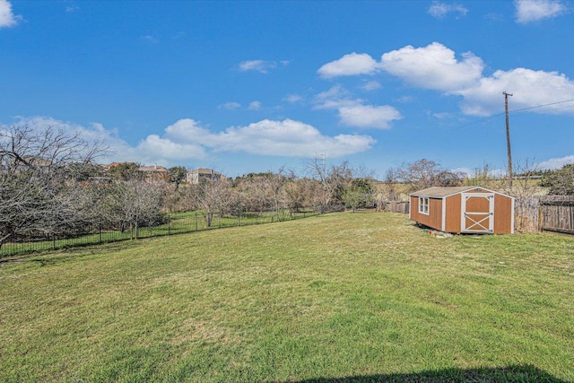 view of yard featuring a fenced backyard, an outbuilding, and a storage shed