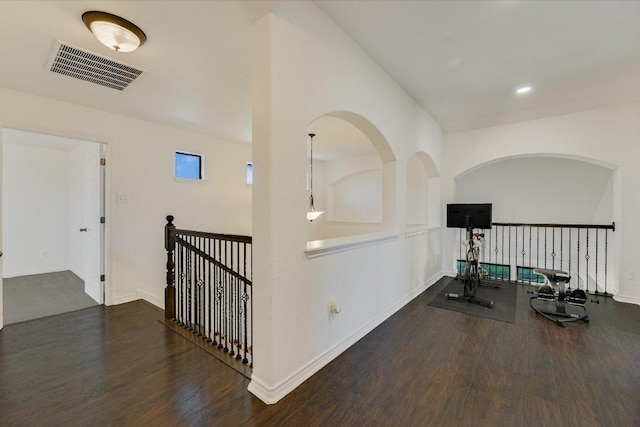 hallway featuring visible vents, an upstairs landing, wood finished floors, recessed lighting, and baseboards