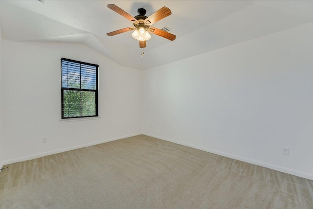 empty room featuring light carpet, visible vents, baseboards, and lofted ceiling