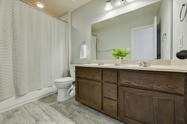 full bathroom featuring toilet, a sink, shower / bath combination with curtain, double vanity, and wood tiled floor