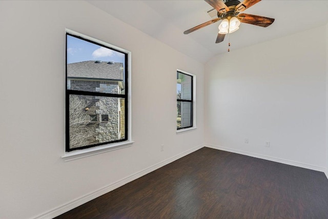 unfurnished room with a ceiling fan, dark wood-type flooring, baseboards, and vaulted ceiling