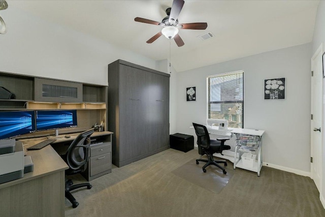 carpeted home office with visible vents, ceiling fan, baseboards, and lofted ceiling