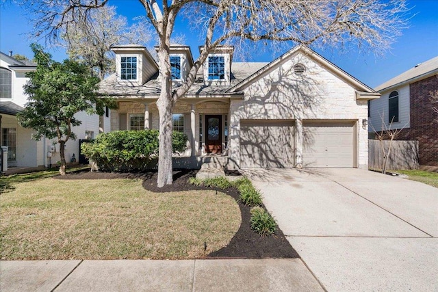 view of front of home featuring a garage, stone siding, concrete driveway, and a front yard