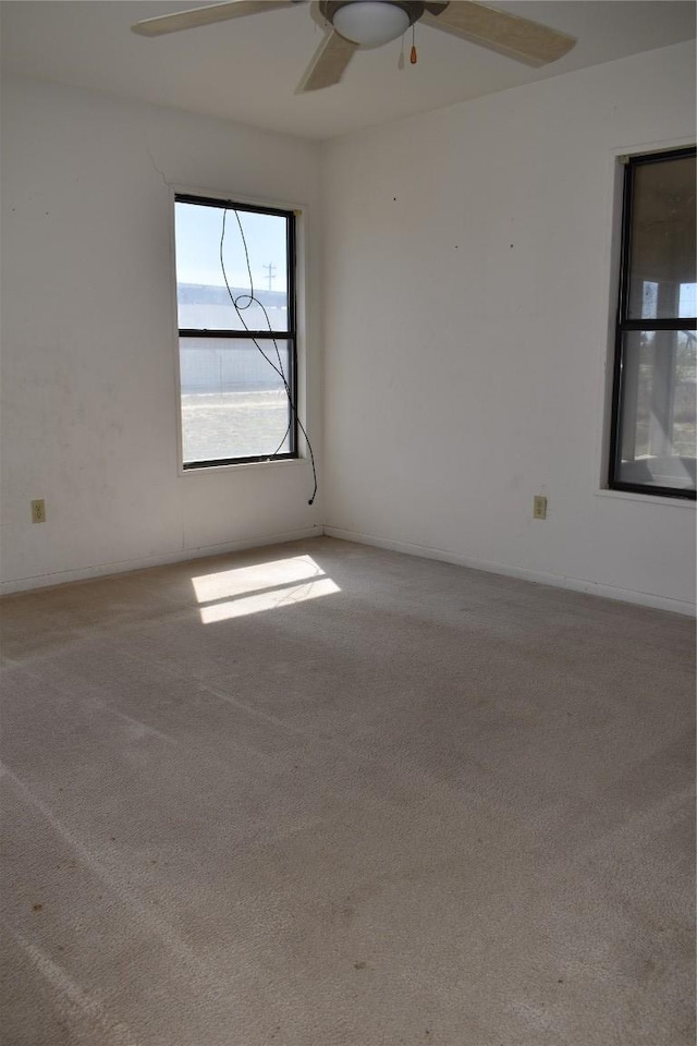 unfurnished room with a ceiling fan and carpet floors