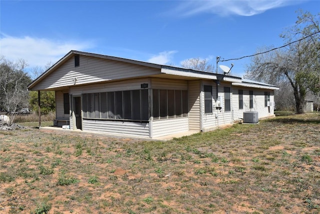 view of home's exterior featuring central AC unit and a sunroom