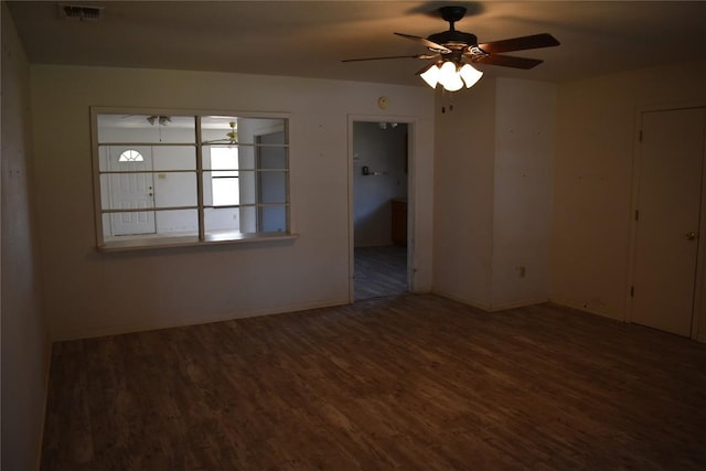 spare room featuring visible vents, ceiling fan, baseboards, and wood finished floors