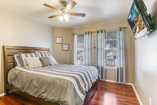 100 Muledeer Ct, Hutto, TX 78634 - bedroom with baseboards, ceiling fan, and wood finished floors