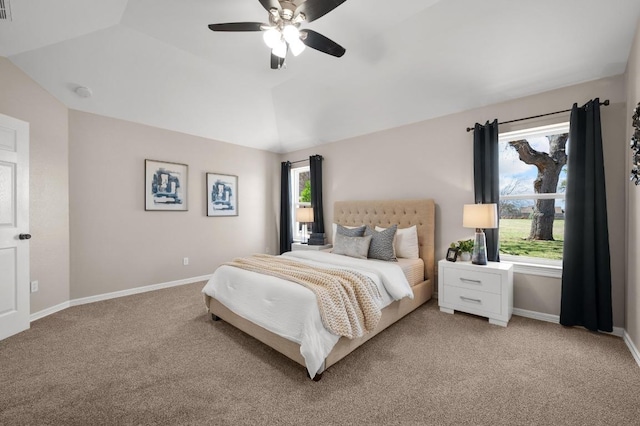 bedroom featuring light carpet, a ceiling fan, baseboards, and vaulted ceiling