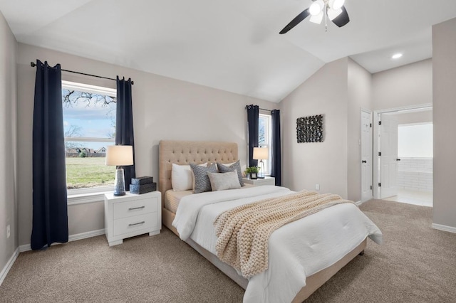 bedroom with light colored carpet, baseboards, and vaulted ceiling