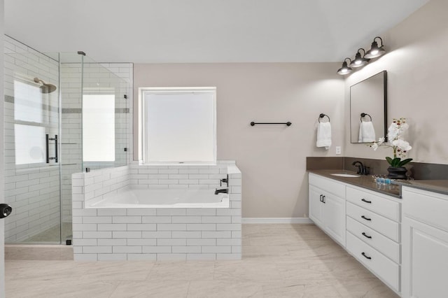 full bathroom with vanity, a garden tub, and a stall shower