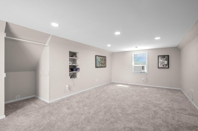 below grade area featuring recessed lighting, built in features, carpet, and baseboards