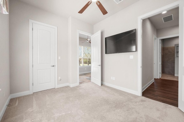 unfurnished bedroom with visible vents, baseboards, carpet, and a ceiling fan