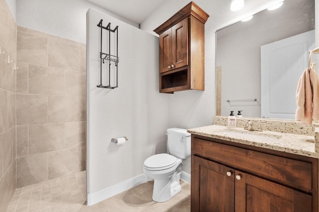 full bath featuring vanity, baseboards, tile patterned flooring, walk in shower, and toilet