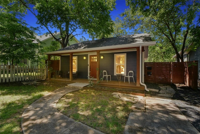 view of front of property featuring a porch and fence