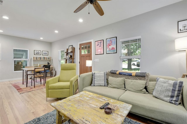 living area with a ceiling fan, light wood-style flooring, recessed lighting, and baseboards