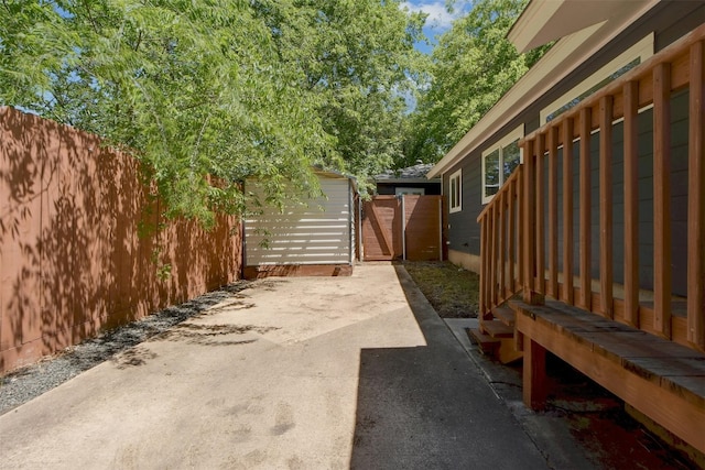 view of patio featuring an outdoor structure and fence