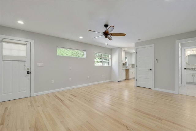 unfurnished living room featuring recessed lighting, a ceiling fan, light wood-type flooring, and baseboards