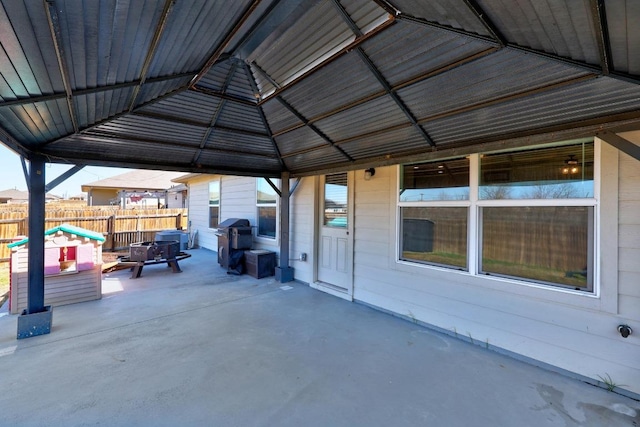 view of patio with area for grilling and fence