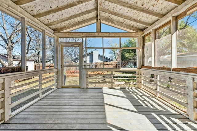 unfurnished sunroom with lofted ceiling