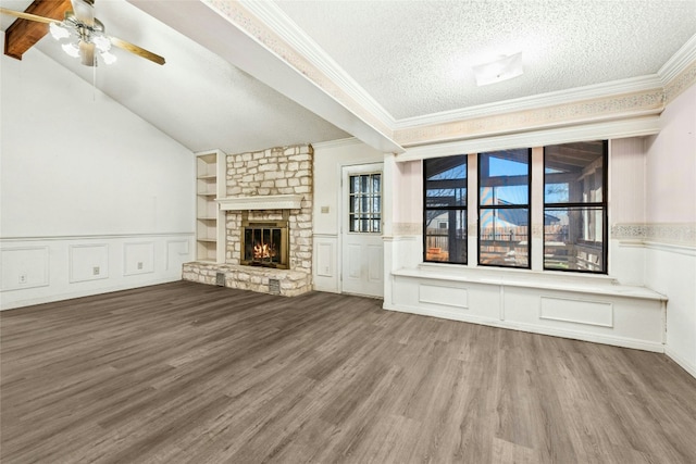 unfurnished living room with a fireplace, a textured ceiling, crown molding, and wood finished floors