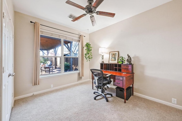 office space featuring carpet flooring, baseboards, visible vents, and ceiling fan