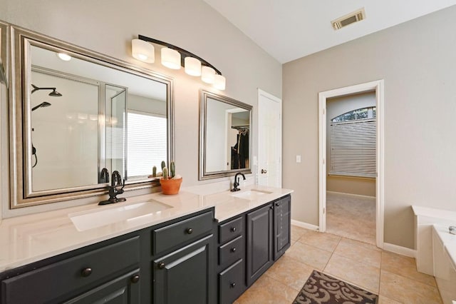 full bathroom with a sink, visible vents, a garden tub, and double vanity